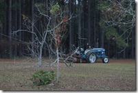 Mom driving the tractor that was attached to the rope that we brought from home that was tied to the tree that was struck by lightning 